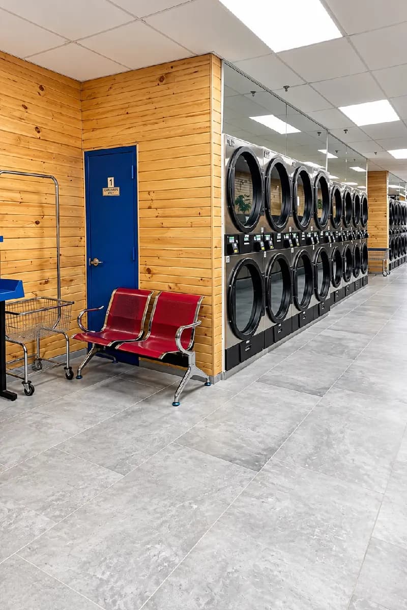 Row of dryers and red waiting benches inside the store